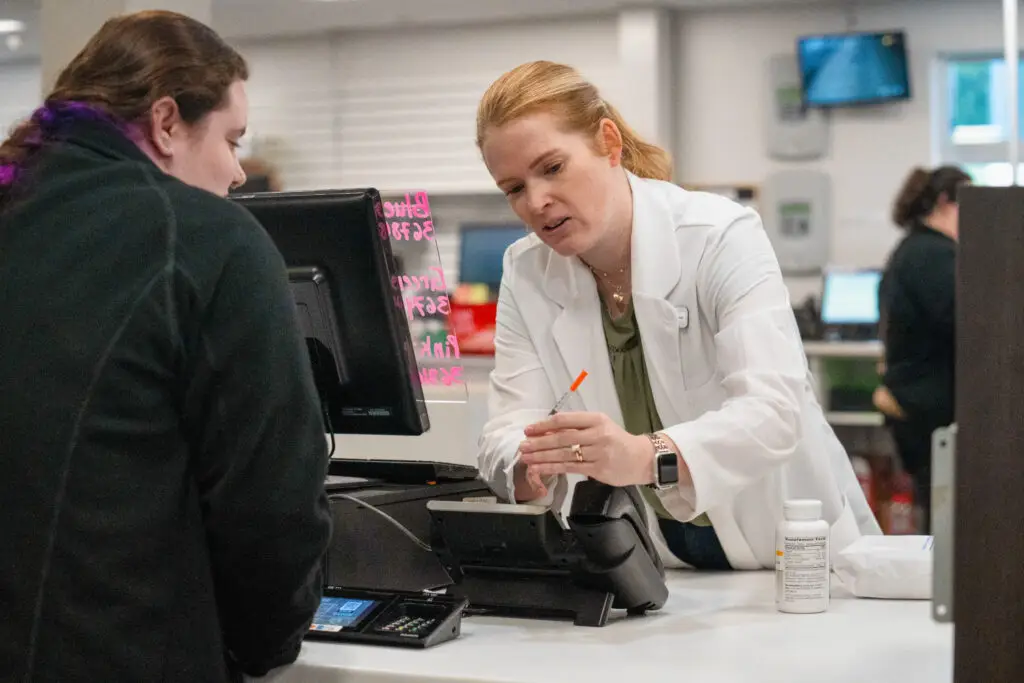 Westmoreland front desk communicating with patient about injection image